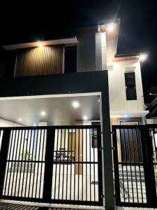 a house with a black gate in front of it at Couple Room near Clark (Casa Isabela) in Mabalacat