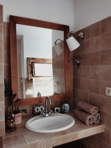 a bathroom with a sink and a mirror at Old Town Apartment in Liptovský Mikuláš