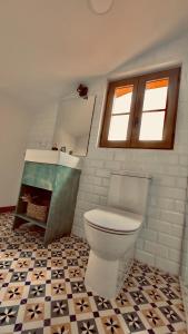 a bathroom with a toilet and a tile floor at CASA MEIGO in Chantada