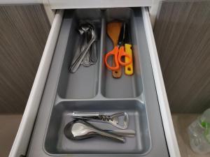 a drawer with scissors and other kitchen utensils at 7 Floor - Ozone Condotel near Kata beach by 15 minutes walking in Kata Beach