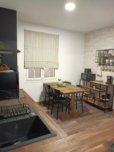 a kitchen with a table and chairs in a room at Apartamento Solpor in Malpica