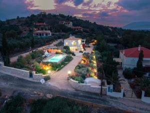 a villa with a swimming pool at night at Villa Alexandros in Ermioni
