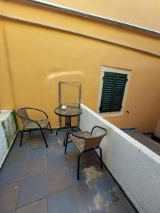 two chairs and a table on a balcony at Elim in Rovinj