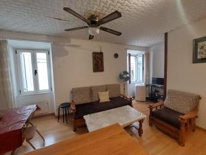 a living room with a couch and a ceiling fan at Elim in Rovinj
