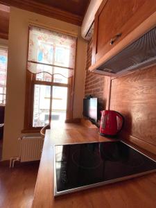 a kitchen with a microwave and a stove top oven at Authentic Turkish Home in Istanbul