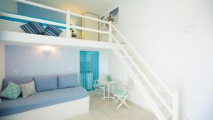 a bedroom with a bunk bed and a table at Nissos Suites in Apollonia