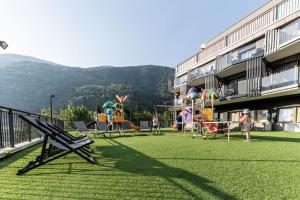 a balcony of a building with a playground at Ravelli Sporting in Mezzana