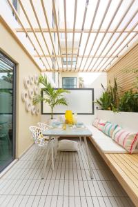 a patio with a white couch and a table at Sal Serenity Suites - New apartment in Santa Maria