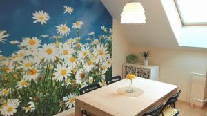 a dining room with a flower mural on the wall at Vila Květ in Třeboň