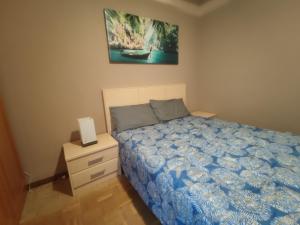 a small bedroom with a bed and a nightstand at apartamento centro in Vitoria-Gasteiz +1 photo