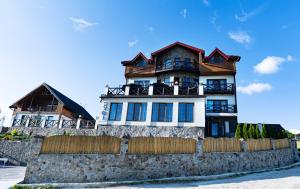 a large house on top of a stone wall at SVOI Hotel in Palyanytsya