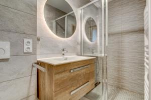 a bathroom with a sink and a mirror at Chalet Arthur in Morzine