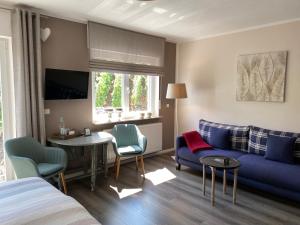 a living room with a blue couch and a table at Weinburg -Das Ferienhaus in Cochem