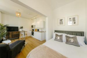 a bedroom with a bed and a living room at Grange Road Studio 4 in Bristol