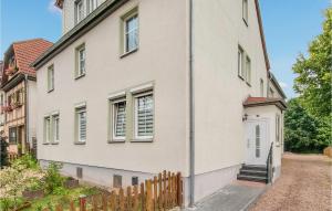a white house with a white door and a fence at 2 Bedroom Nice Apartment In Friedrichroda in Friedrichroda