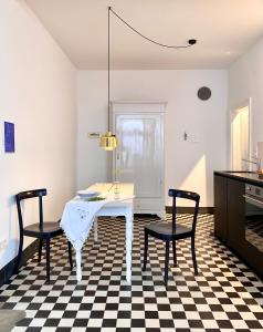 a dining room with a table and two chairs at zehuus - historical charm 70qm in Cologne