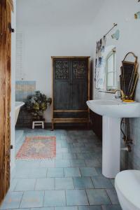 a bathroom with a sink and a toilet and a door at Jemna 55 in Jemna +24 photos