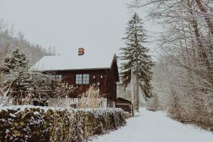 a log cabin in the snow with a fence at Jemna 55 in Jemna