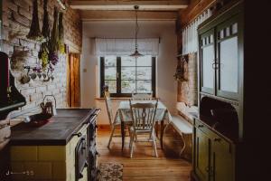 a kitchen with a table and a dining room at Jemna 55 in Jemna