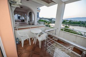 a balcony with a table and chairs on a building at SUNLIGHT in Ulcinj