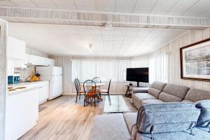 a living room with a couch and a table at The Dockhouse Cottage Five in Wasaga Beach