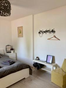 a bedroom with a bed and a desk with a laptop at LillasLavender Kurzeme in Ošenieki