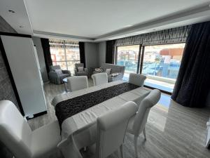 a bedroom with a bed with chairs and a large window at Penthouse 4 bedrooms, 1 living room, to the sea 7 minutes walk in Alanya