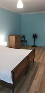 a bedroom with a bed and a dresser at уют in Rustavi