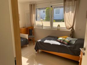 a small bedroom with a bed and a window at DreiländerOase in Perl