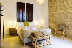 a bedroom with a bed with two towels on it at Casa de los Venerables in Seville