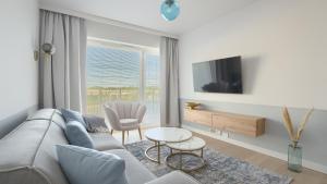 Televízia a/alebo spoločenská miestnosť v ubytovaní Apartamenty Sun & Snow Polanki Aqua z basenem