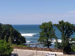 a view of the ocean from a parking lot at Апартамент White apartment град Китен in Kiten