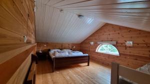 a room with a bed in a attic with a window at Leilighet v Hardangerfjorden in Hesthamar