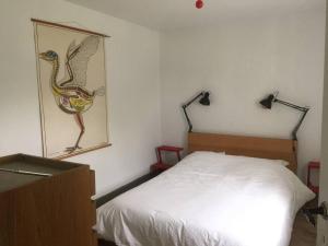 A bed or beds in a room at Gîte le tilleul