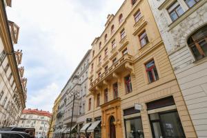 a row of buildings on a city street at Stunning Charles Bridge Apartment in Prague