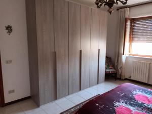 a bedroom with a large wooden cabinet in a room at Casa vacanza Gianna in Manduria