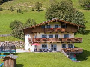 a large house with a balcony and a playground at Almliesl GOLD-705 in Maierhof