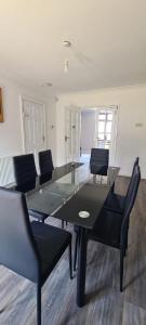 a dining table and chairs in a room at Thorpe House Suites in Heeley
