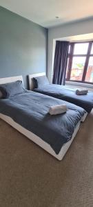two beds sitting next to each other in a bedroom at Thorpe House Suites in Heeley