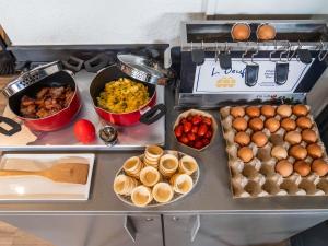 a buffet with different types of food on a counter at ibis Saint Gratien - Enghien-Les-Bains in Saint-Gratien