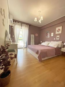1 dormitorio con cama, escritorio y planta en Πολυτέλεια και ηρεμία στο κέντρο των Β.Προαστίων.., en Atenas
