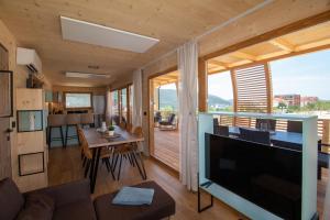 a living room with a large television and a table at Camp Ante-Gojko in Grebaštica