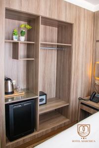 Zimmer mit einem TV und einer Holzwand in der Unterkunft Marchica Hotel in Nador