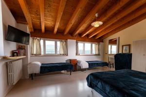 a room with two beds and a flat screen tv at BB Molina in Molina