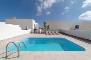 a swimming pool on the side of a villa at Villas Yaiza in Playa Blanca