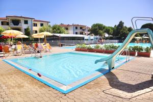 a swimming pool with a slide in a resort at Appartamento vista mare in Porto Recanati