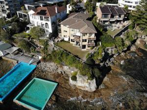 an aerial view of a house with a swimming pool at Waterfront on Manly Harbour in Sydney
