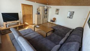 a living room with a large couch and a table at Ferienwohnung Weber in Freyung