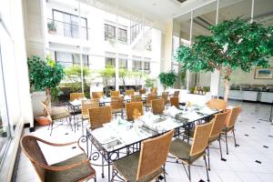 a dining room with tables and chairs in a building at Kantary Bay Hotel And Serviced Apartments Sriracha in Si Racha