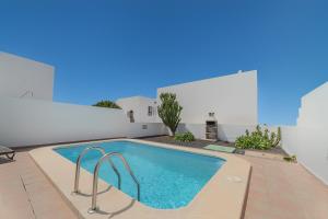 a swimming pool in the backyard of a villa at Villas Yaiza in Playa Blanca